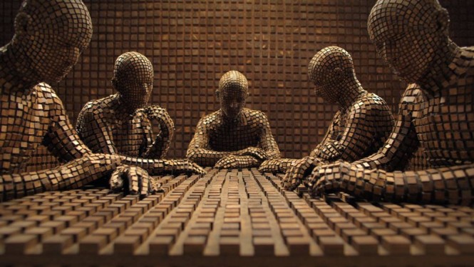 Still image from the film, a sculpture of four human shaped figured constructed from small cubes